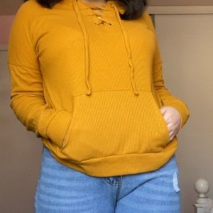 mustard colored hoodie.